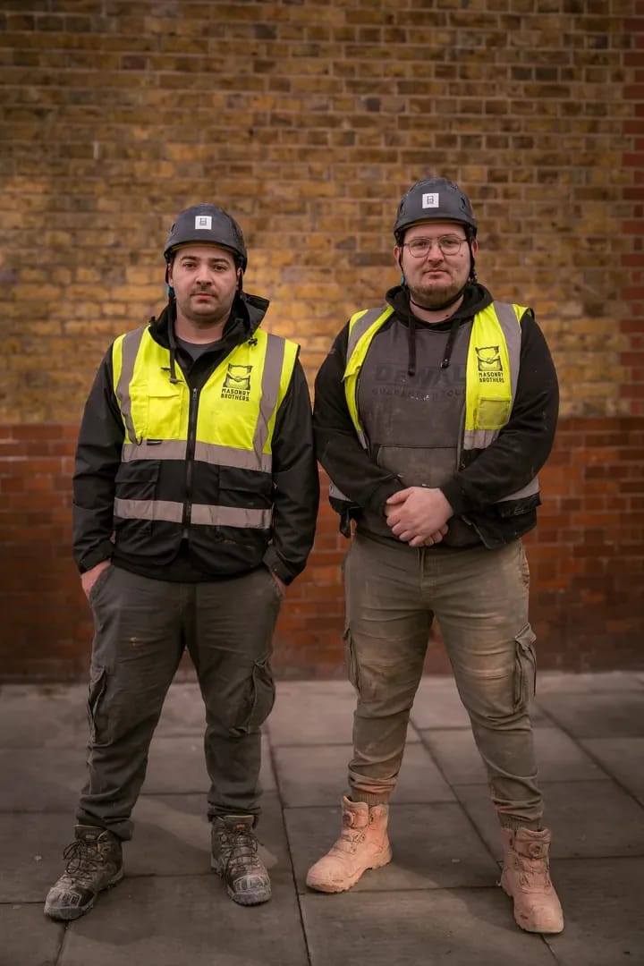 Master craftsman performing detailed masonry work