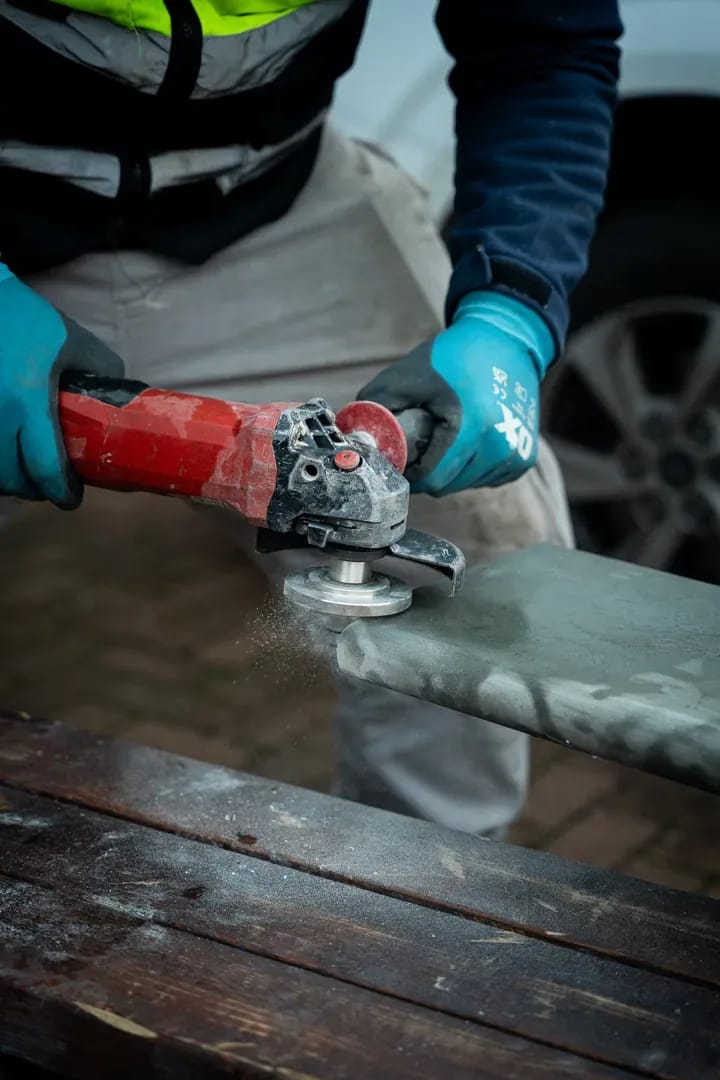 Close-up of precision stone grinding with hands and tools